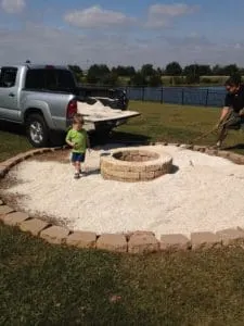 adding the pea gravel around the DIY Fire Pit 