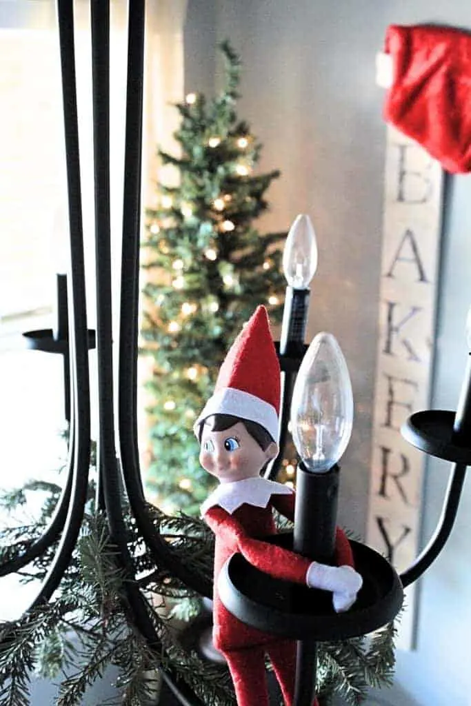 Elf on the shelf in the chandelier