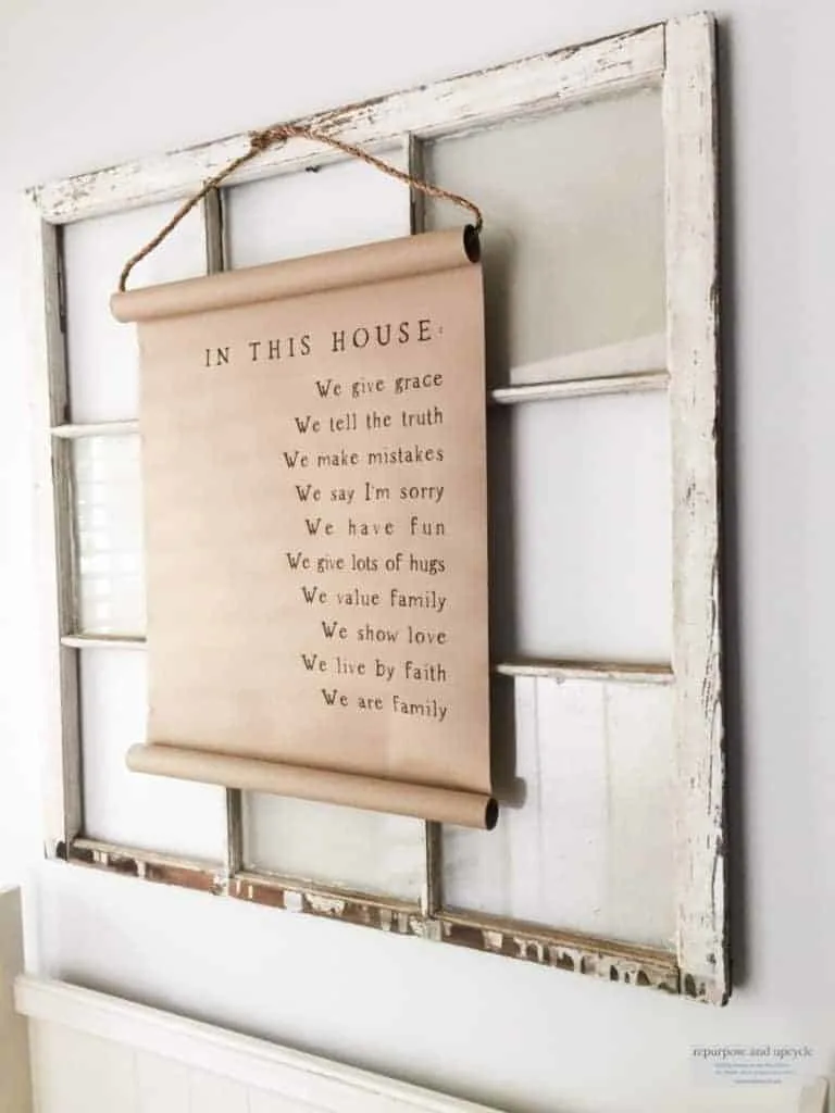 rustic beach cottage entryway with scroll sign and antique window