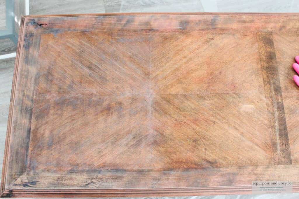 Applying liming wax to a coffee table