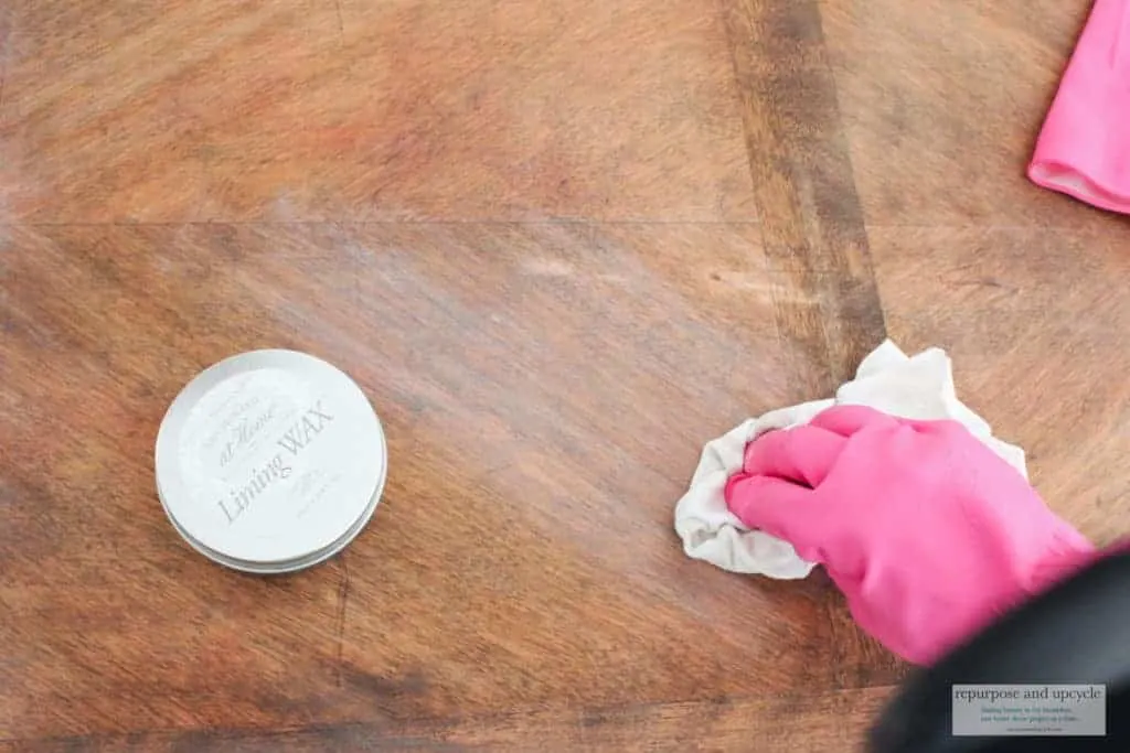 Applying liming wax to a coffee table
