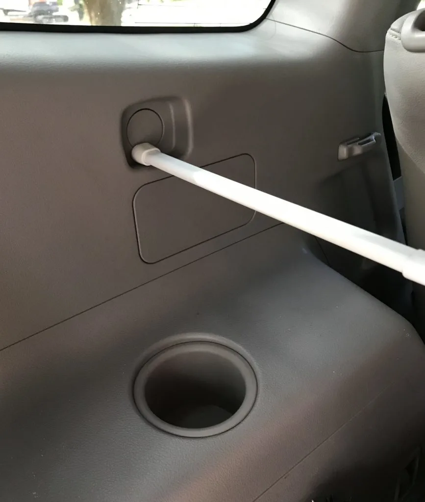 installing tension rod in car for car organization 