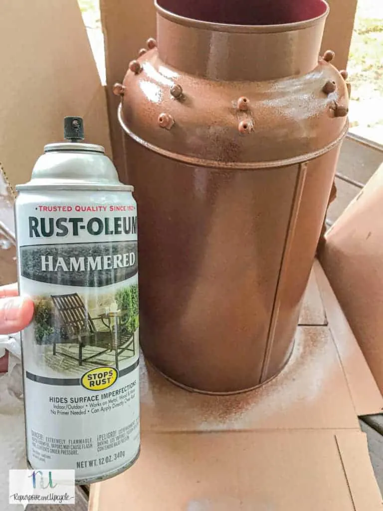 first coat of copper spray paint on the milk can 