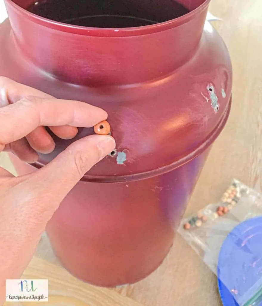 adding a few beads to the old milk jug