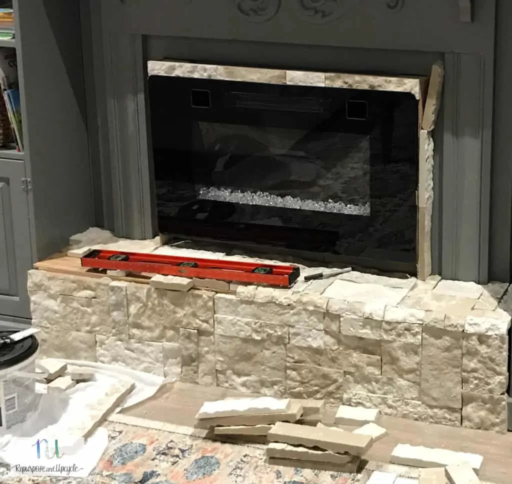 applying AirStone around an electric fireplace 