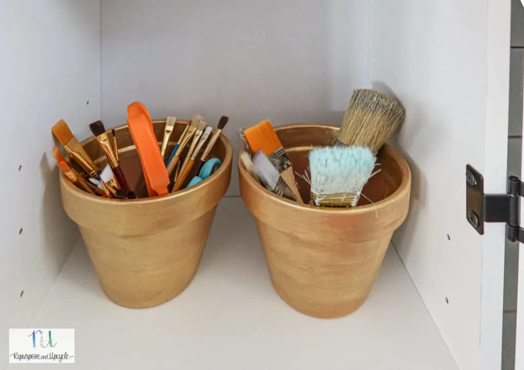 paint brushes organized in a craft cabinet