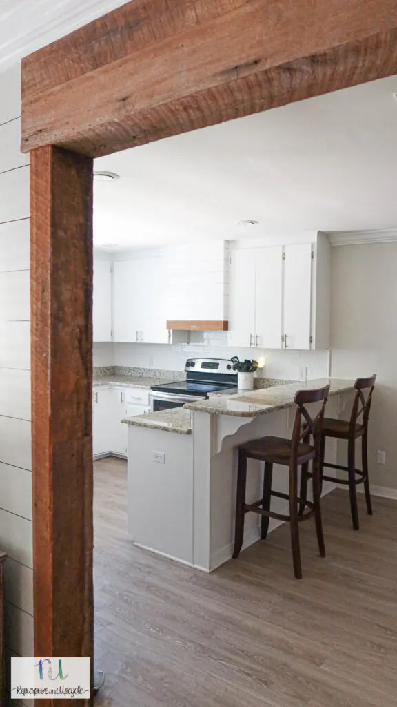 exposed wood beams into white kitchen