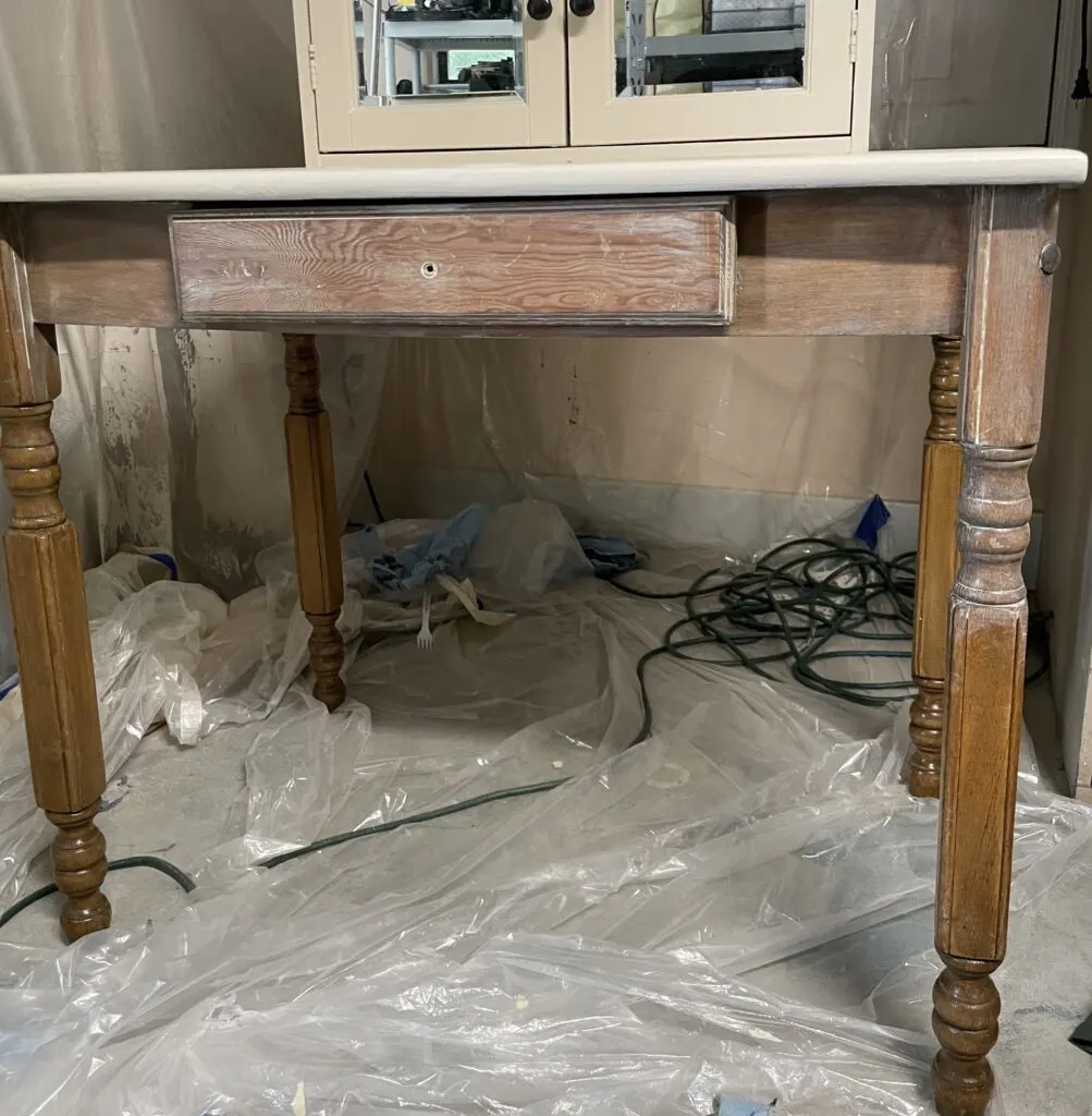 applying paint wash to desk 